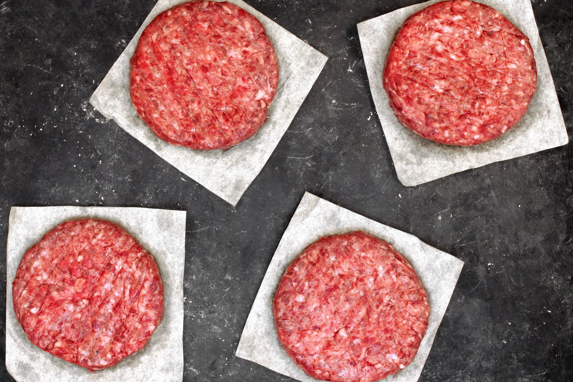4 Ground Beef Hamburger Patties on Paper